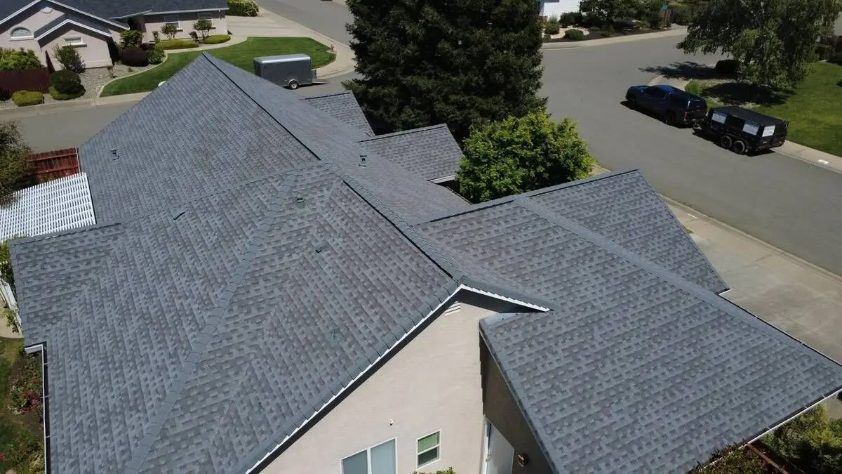 Multi-section shingle roof with new ridge caps