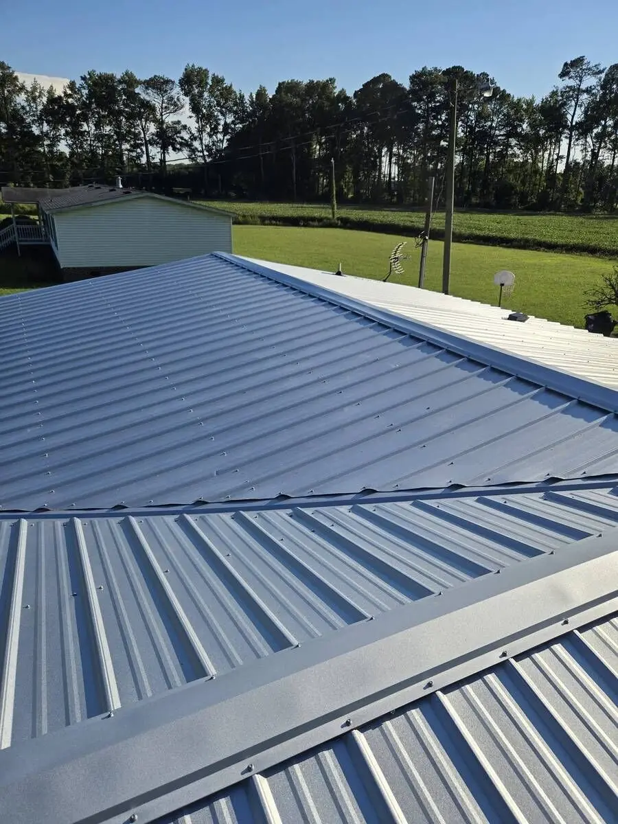 Metal roof installation with ridge cap by Forest Construction NC